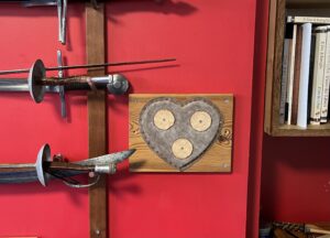 Wall target put up during my 7 day data detox. Leather and wood, on a red wall.